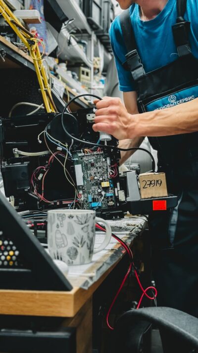 technician repairing printer in workshop